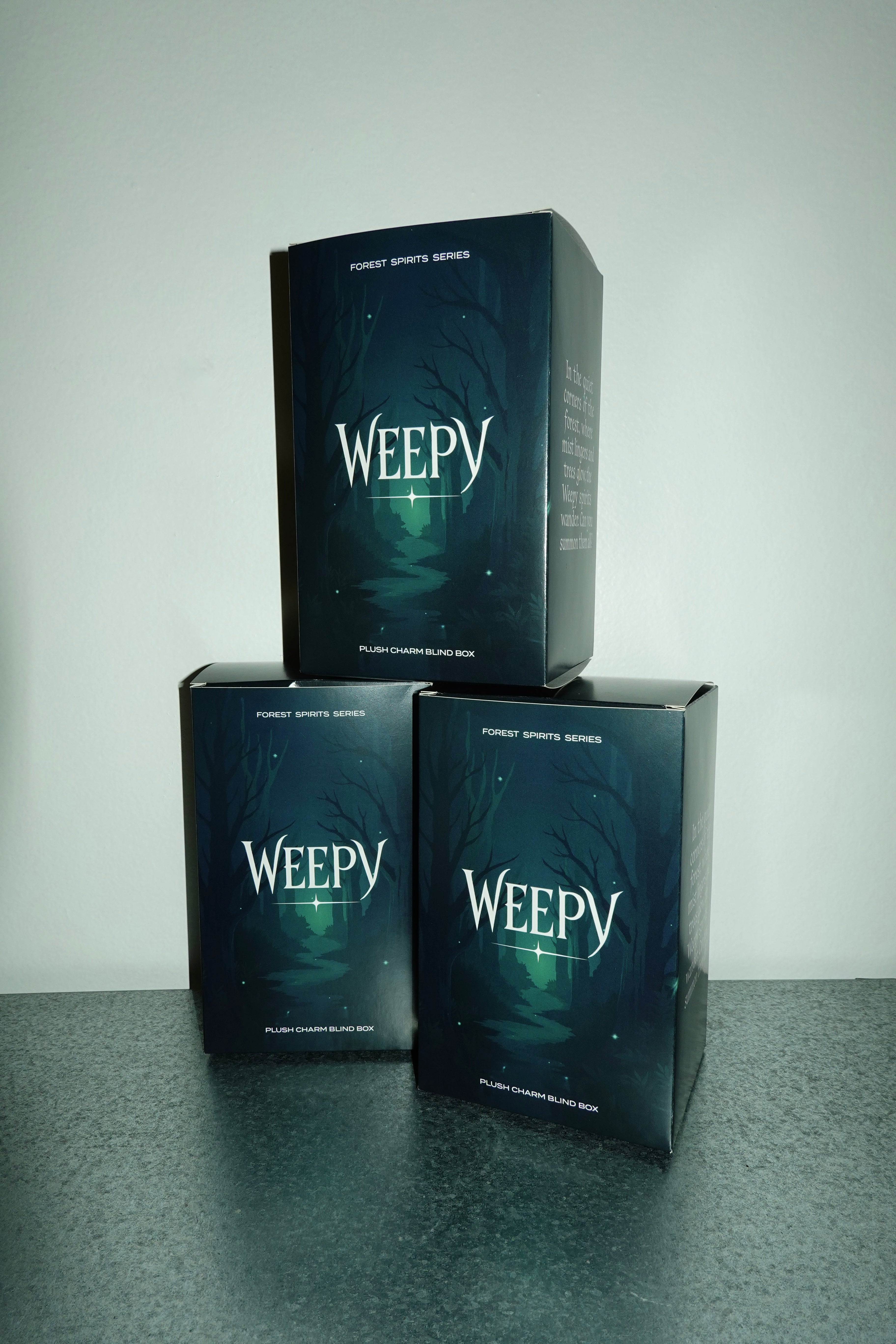 Three 'Weepy' plush charm blind boxes stacked on a gray surface with a white background